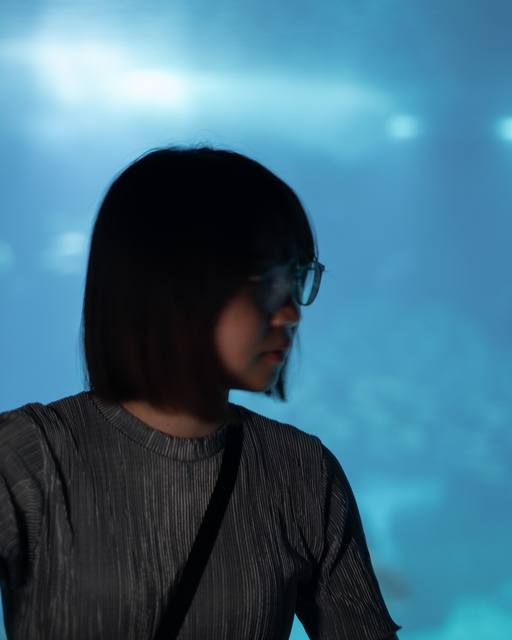 woman before a glowing blue tank
