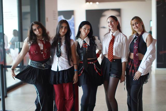 group of five in school-uniform cosplay
