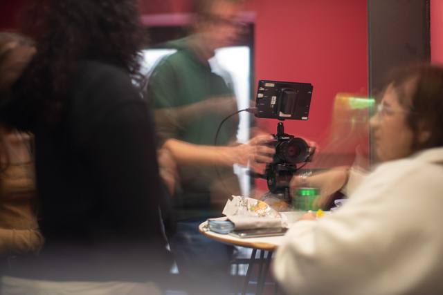 red-lit interior, operator with rig, subject with cake