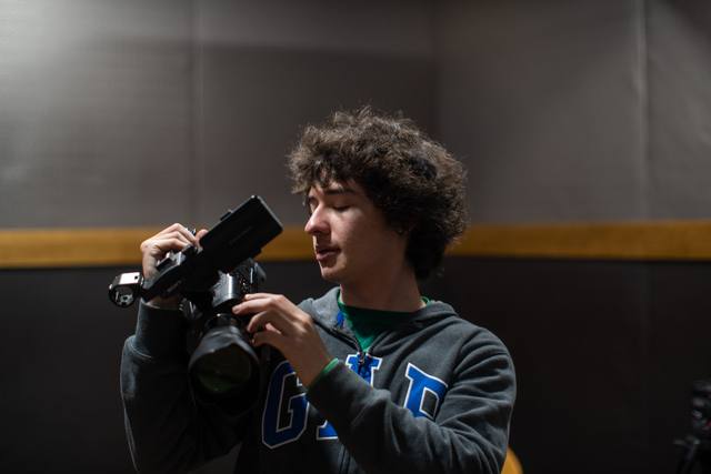 portrait of an operator holding a cinema camera