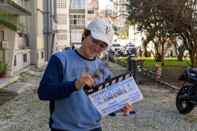 crew member holding a slate on an outdoor set