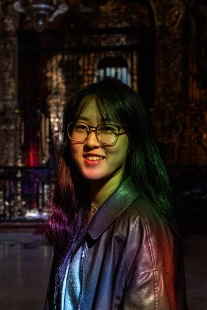night portrait, green-lit hair, glasses
