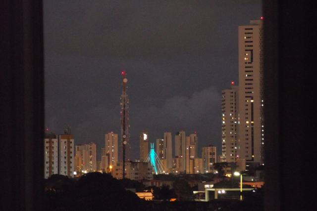 night city with a lit tower, shot through glass